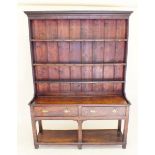 An 18th century oak and pine Welsh dresser with plate rack consisting two single drawers with