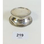 A small silver capstan inkwell with blue glass liner, indistinct hallmark. Gross weight 126 grams.