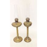 Two late 19thC oil lamps with glass funnels, tallest 70cm.