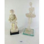 A Parian style figure of a putti reading and a simulated glass figure of a ballet dancer
