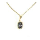 A 9ct gold necklace chain with yellow metal and cats eye cabochon amethyst pendant