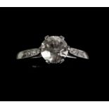 A platinum solitaire diamond ring on a diamond chip shoulder, the central stone 1.1 cts