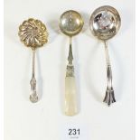 A silver sifter spoon and two silver plated ones
