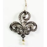 An Edwardian diamond set scrollwork pendant/brooch with pearl drop and detachable brooch pin, 7g