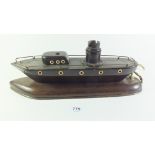 A 1920?s table lamp base in the form a wooden ship with ivory porthole windows, 35cm long