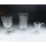 An Edwardian large glass beaker with panel cut sides, together with two other pieces of 19th century