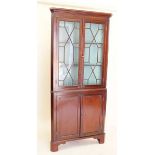 A 19th century mahogany corner cupboard with glazed upper display section
