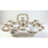 A Tuscan 'Lorraine' pattern tea set to include six trios, sugar bowl, milk jug and cake plate.