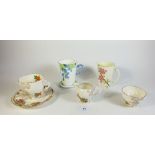 A Royal Cauldon floral trio with milk and sugar plus a Foley floral painted mug retailed by