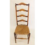 A rush seated ladder back chair