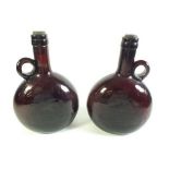 A pair of early 20th century brown glass flasks