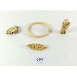 Two carved bone brooches, a 19thC Japanese ivory netsuke and an antique ivory bangle.
