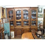 A large 20th century French provincial style glazed four section kitchen storage cabinet with pull