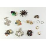 A selection of costume jewellery brooches and a pair of yellow metal hoop earring