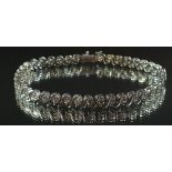 A white gold diamond set tennis bracelet, 18.2cm, 17.8g (total diamond weight 4 ct)