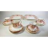 A late 19th century Wedgwood part tea service in a rust pink colourway, consists of three cups,