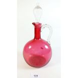 A Victorian cranberry glass decanter with stopper