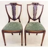 A pair of unusual Edwardian mahogany shield back chairs with swag decoration all on spade fronted