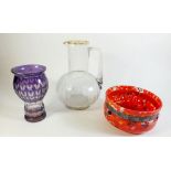 A Victorian purple flashed and cut glass vase, a Victorian glass jug and a spattered glass bowl