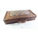 A resin chess set in carved wooden chess board case