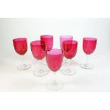A set of six 19th century cranberry glasses and one similar.