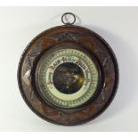 A carved mahogany circular barometer