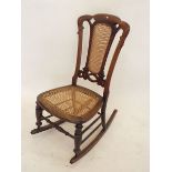A Victorian mahogany cane seated rocking chair
