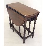 A 1920's oval oak supper table on barleytwist supports