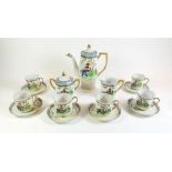 A Japanese coffee set painted landscape comprising:- coffee pot, milk, sugar and six cups and