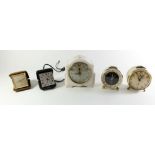 A Swiss eight day travel alarm clock, two vintage Kienzle alarm clocks, one other alarm clock and
