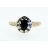 A 9 carat gold sapphire and chip diamond ring