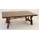 A large mahogany coffee table on scroll legs united by metal stretcher 132 x 75cm
