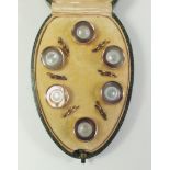 A set of boxed mother of pearl and gilt buttons