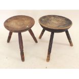 Two 19th century elm circular topped milking stools