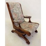An American oak floral carved rocking chair