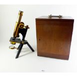 A compound achromatic microscope by R & J Beck on tripod feet in original wooden case