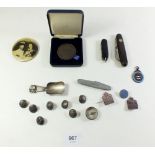 A box of various collectables to include military buttons, enamel badges and penknives