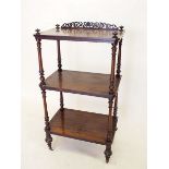 A 19thC rosewood three tier etagere, with scrollwork back and turned supports, 100cm.