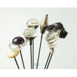 Seven various hat pins including glass