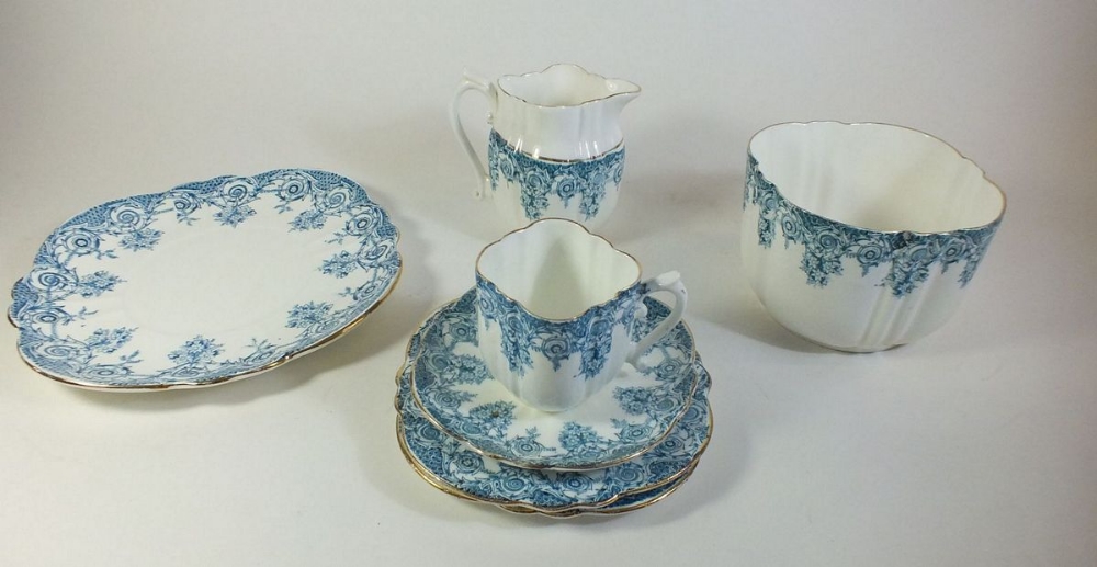 An Edwardian tea service with blue printed decoration comprising twelve cups and saucers (one cup