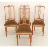 A set of four Edwardian satinwood dining chairs with marquetry interlaced splat back