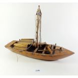 A wooden model of a boat, 35cm long