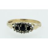 A 9 carat gold three stone sapphire and diamond ring, 1.4g