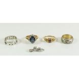 Four various dress rings and a silver cat charm