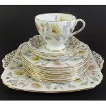 A Foley Somerset tea service comprising seven cups and saucers, cake plate, milk, sugar and three