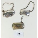 A silver Madeira decanter label with two silver plated labels for Claret and Brandy.