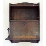 An oak smokers wall cabinet with pipe rack and cupboard
