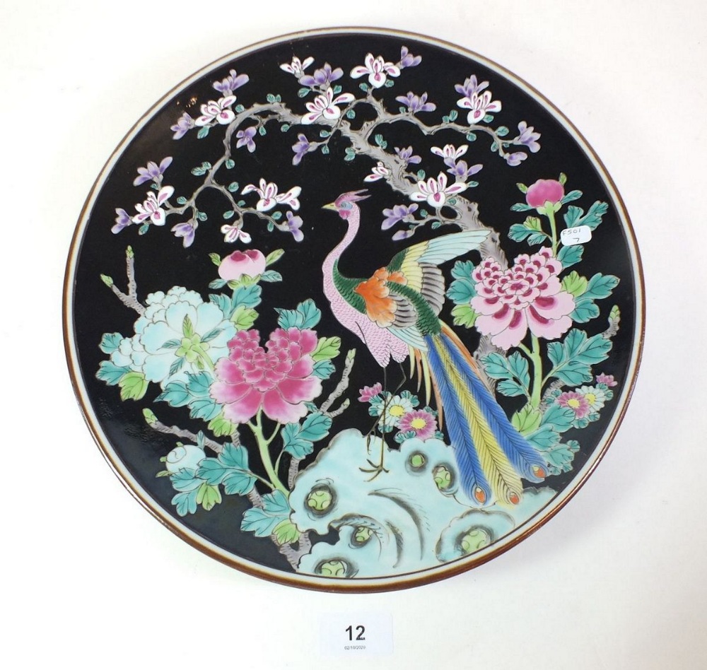 A 20th century Chinese plate painted bird on a black floral ground, 31cm diameter