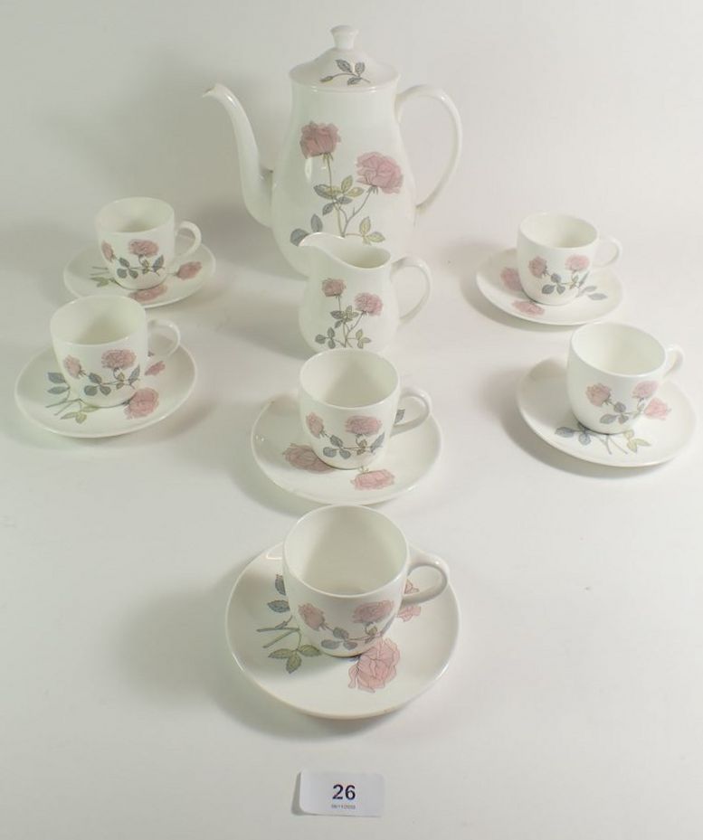 A Wedgwood 'Flame Rose' coffee set comprising six cups and saucers, coffee pot and cream jug