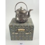 A Chinese white metal small teapot with applied decoration, boxed